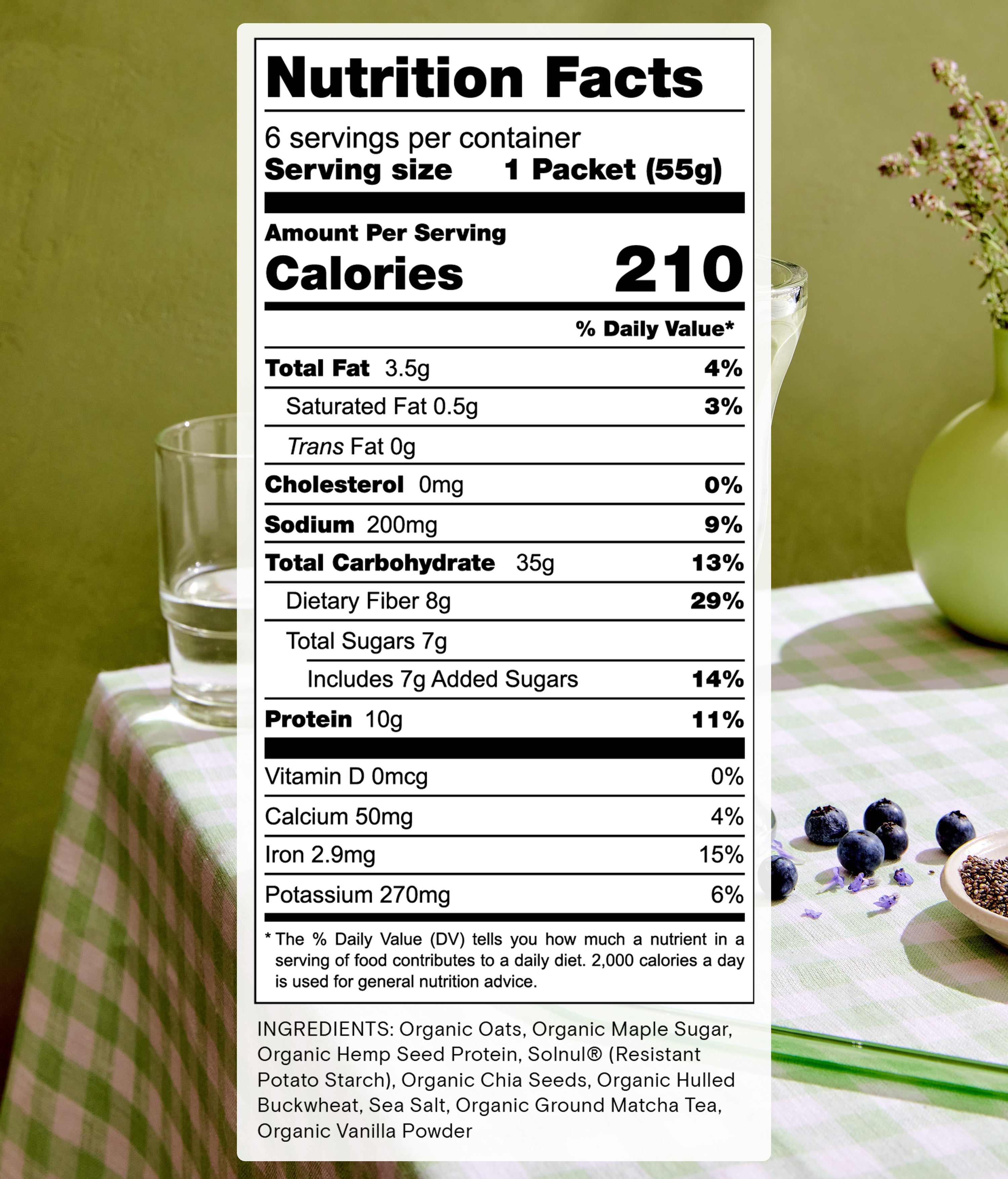 A nutrition facts label for a product measuring 55g per serving. It provides details like 210 calories, 10g protein, and 35g total carbohydrates. Ingredients include organic apple sugar and hemp seed protein. A green cup and blackberries are in the background.